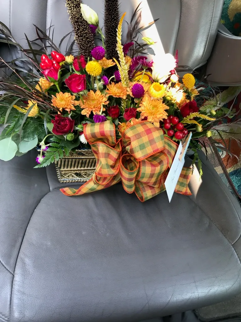 Autumn arrangement with plaid burlap ribbon