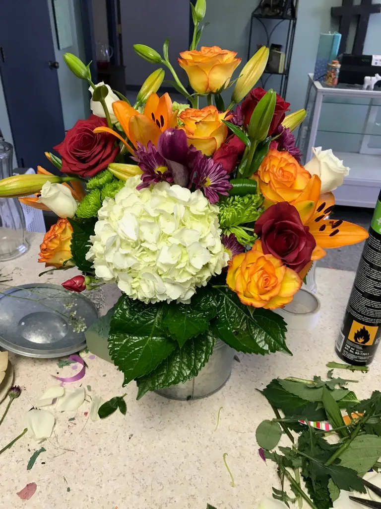 Autumn arrangement with hydrangea, roses and orange lilies